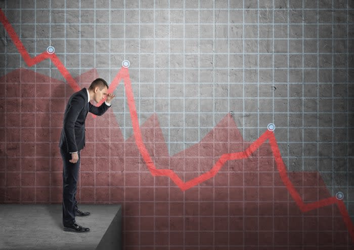 A person watching a plunging chart.